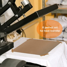 Heat transfer setup with a press and a piece of brown paper on a white surface.